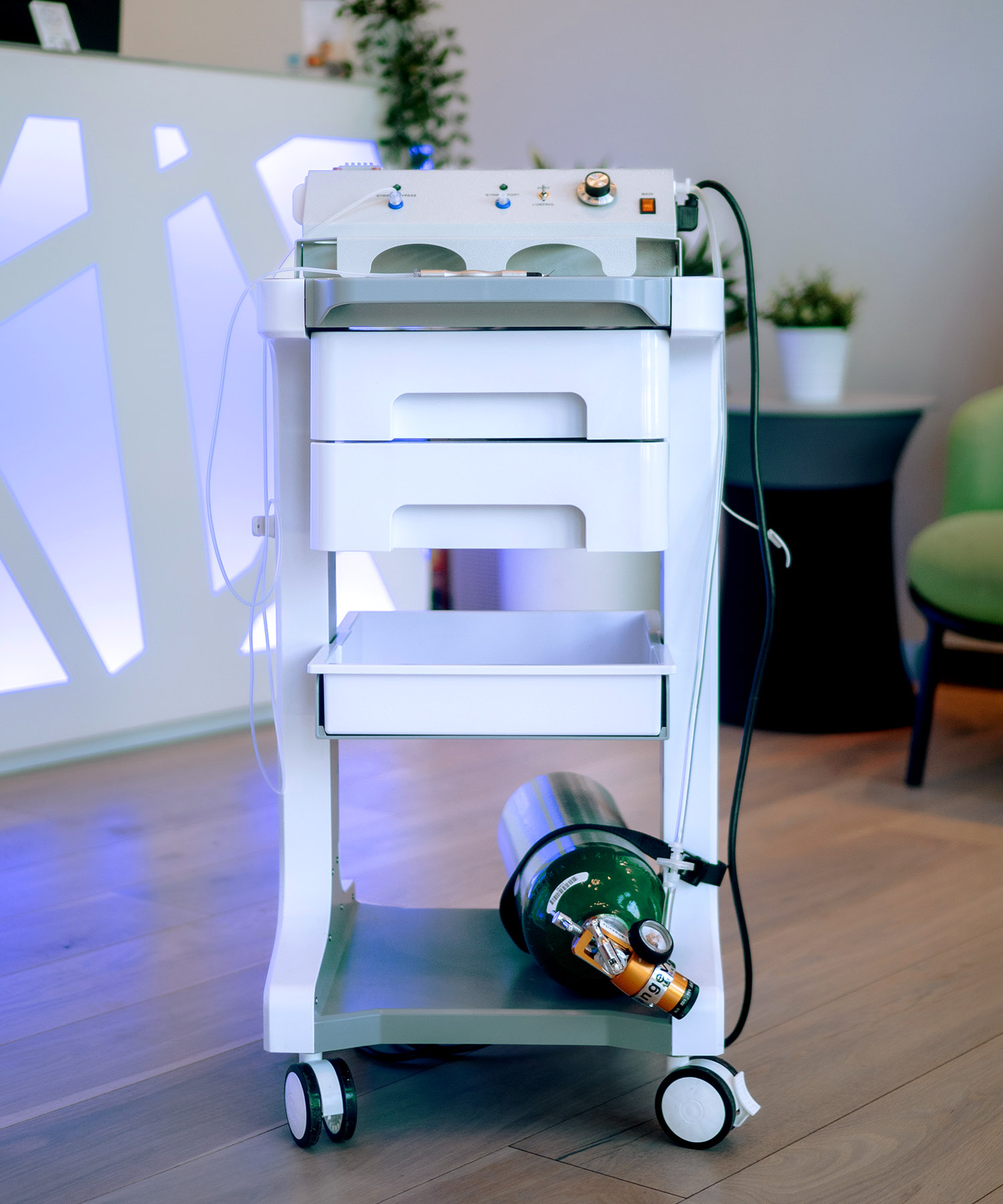 An oxygen-ozone dental therapy cart equipped with a medical gas cylinder, used during safe root canal removal to support healing and reduce microbial burden.